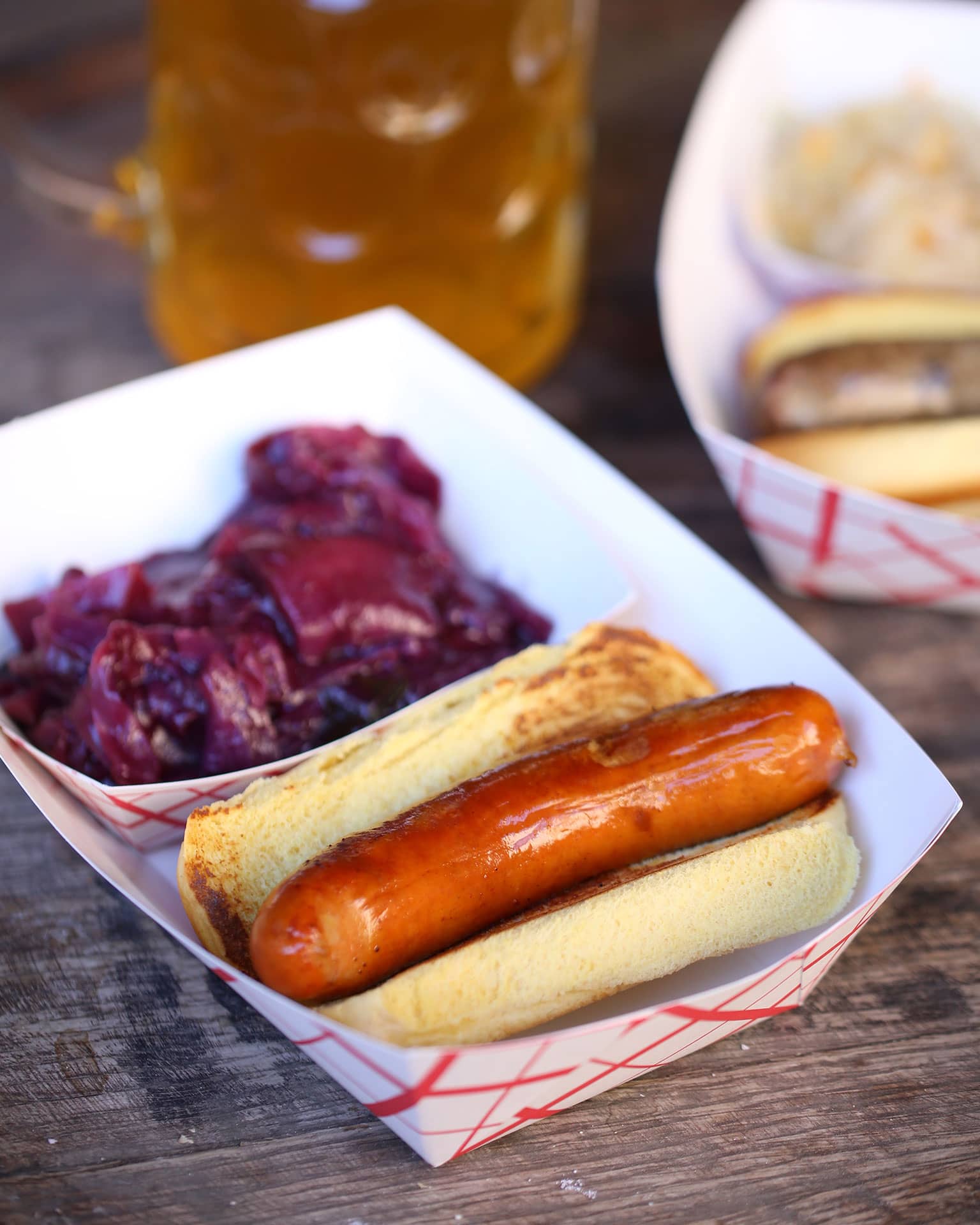 A bratwurst in a Martin's roll with a side of sauerkraut.